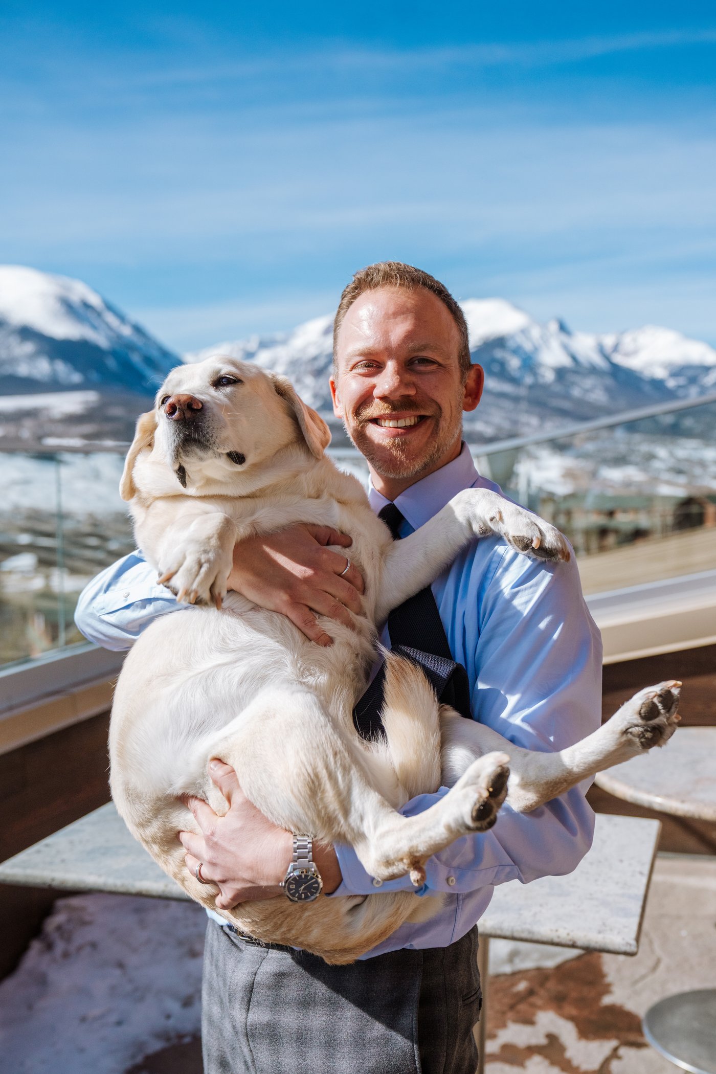Joshua Taylor holding Honey with Colorado mountains behind